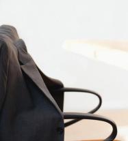 photo of an empty chair with a jacket on it