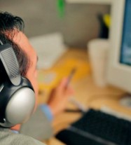 photo of man listening to telephone calls