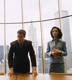 photo of two people at board room table