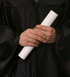 image of graduate holding graduation scroll