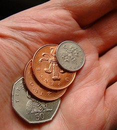 image of a hand holding some coins